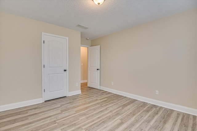 2030 Lake Forest Dr, Grovetown, GA 30813 - unfurnished bedroom with light wood-type flooring and a textured ceiling