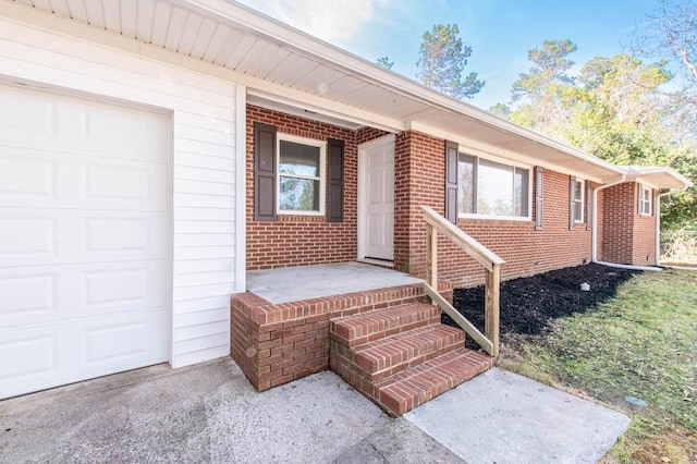 doorway to property with a garage