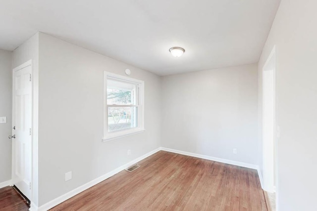 unfurnished room with light wood-type flooring