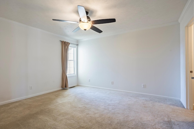 spare room featuring light colored carpet, baseboards, and ornamental molding