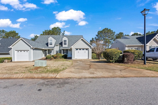 view of front facade featuring concrete driveway, an attached garage, and a shingled roof