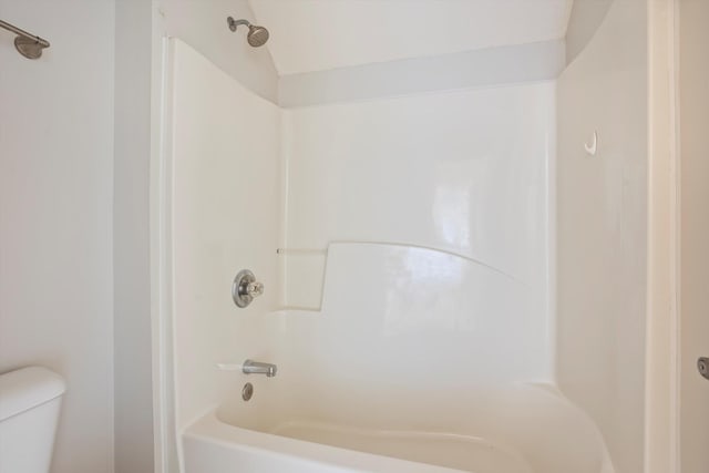 bathroom with toilet and bathing tub / shower combination