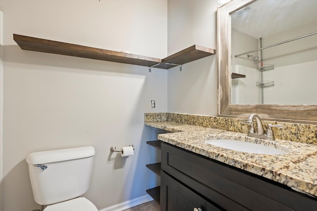 bathroom featuring toilet and vanity