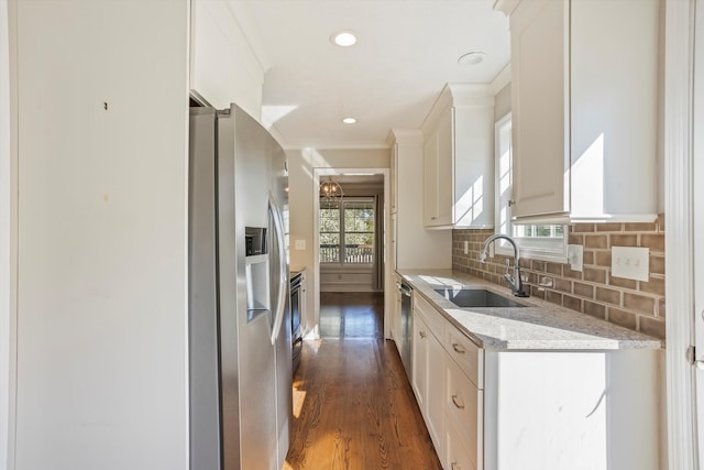 kitchen featuring a sink, tasteful backsplash, stainless steel appliances, white cabinets, and dark wood-style flooring