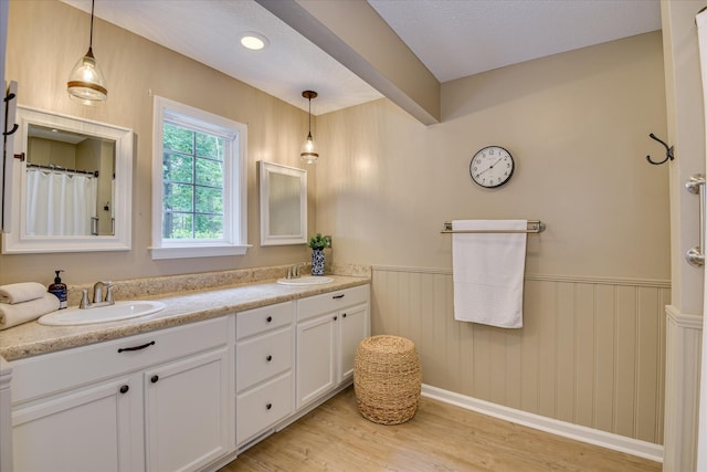 138 Evergreen Ln, Mccormick, SC 29835 - bathroom with a wainscoted wall, double vanity, and wood finished floors