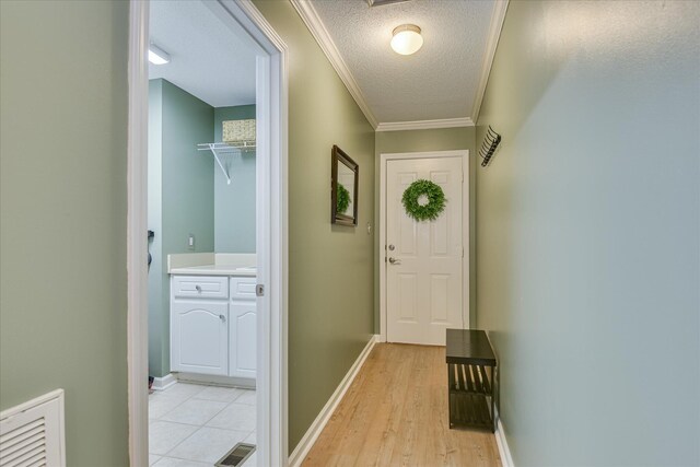 138 Evergreen Ln, Mccormick, SC 29835 - doorway to outside with a textured ceiling, crown molding, light wood-type flooring, and baseboards