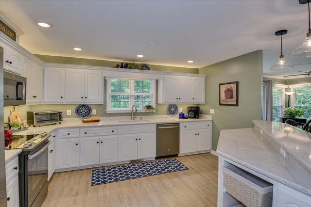 138 Evergreen Ln, Mccormick, SC 29835 - kitchen featuring stainless steel appliances, a sink, white cabinetry, light wood-style floors, and light countertops