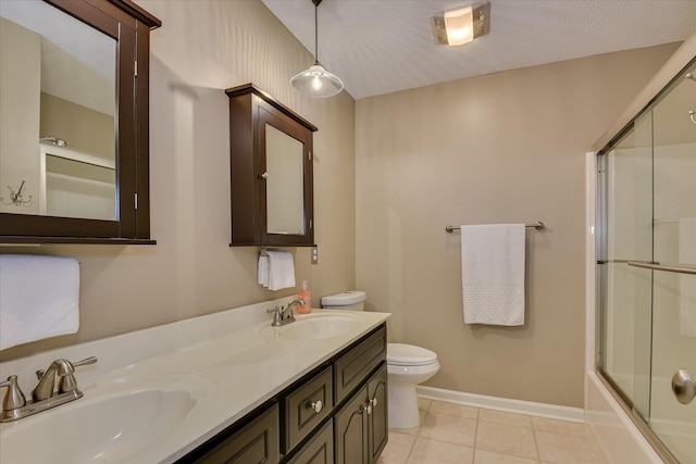 138 Evergreen Ln, Mccormick, SC 29835 - bathroom featuring toilet, double vanity, tile patterned floors, bath / shower combo with glass door, and baseboards