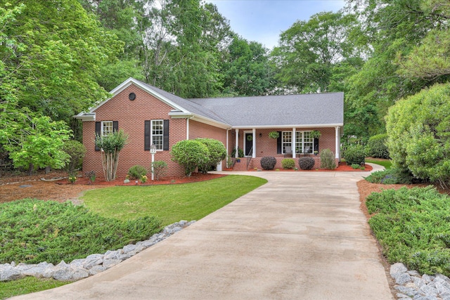 138 Evergreen Ln, Mccormick, SC 29835 - single story home with covered porch, concrete driveway, brick siding, a front yard, and a shingled roof