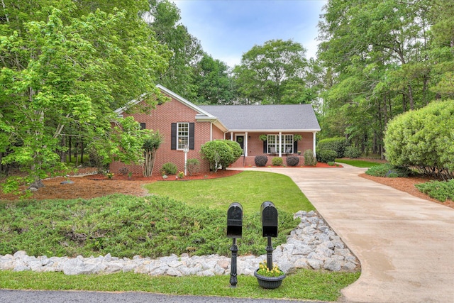138 Evergreen Ln, Mccormick, SC 29835 - single story home featuring concrete driveway, brick siding, covered porch, and a front lawn