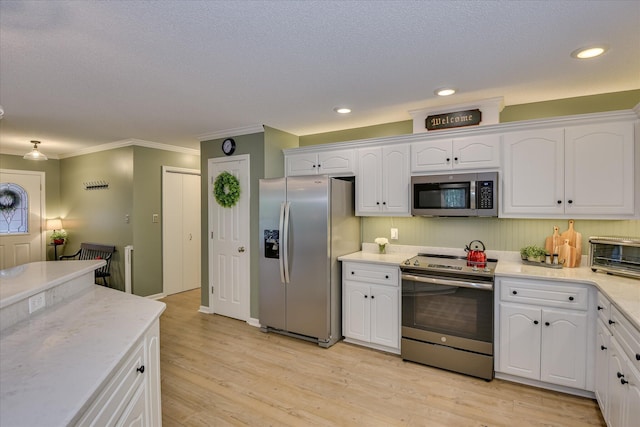 138 Evergreen Ln, Mccormick, SC 29835 - kitchen with stainless steel appliances, white cabinets, crown molding, light wood-style floors, and recessed lighting