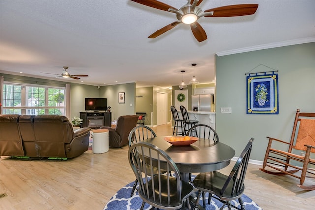 138 Evergreen Ln, Mccormick, SC 29835 - dining room with a ceiling fan, light wood finished floors, crown molding, and baseboards