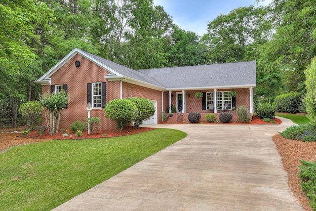 138 Evergreen Ln, Mccormick, SC 29835 - view of front of home featuring covered porch, brick siding, driveway, a front lawn, and a garage