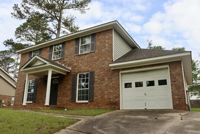 colonial home with a shingled roof, an attached garage, concrete driveway, and brick siding