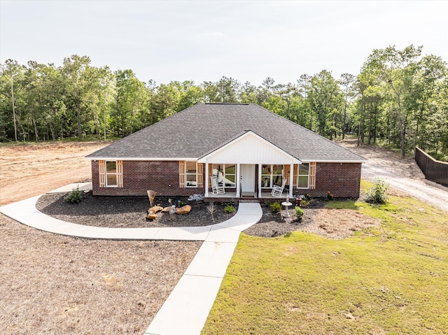 3604 Hillman Gay Rd, Dearing, GA 30808 - ranch-style house with a porch, brick siding, a front lawn, and a shingled roof