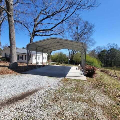 view of car parking featuring a carport and driveway