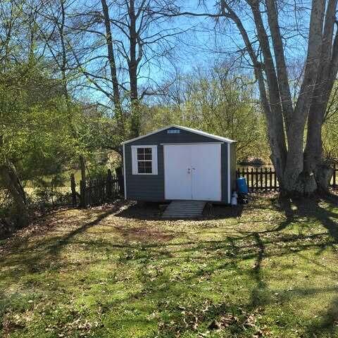 view of shed with fence