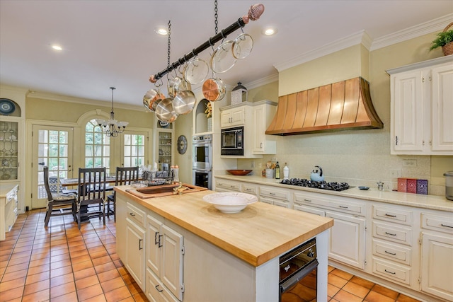 8 Tall Pine Ct, Augusta, GA 30909 - kitchen featuring black appliances, wooden counters, premium range hood, a chandelier, and white cabinets