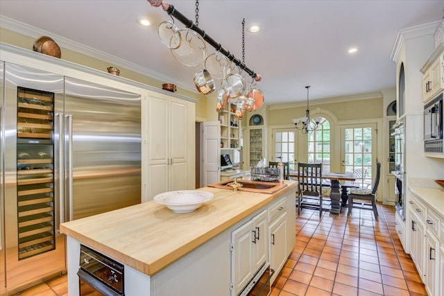 8 Tall Pine Ct, Augusta, GA 30909 - kitchen featuring wood counters, white cabinets, built in appliances, ornamental molding, and recessed lighting