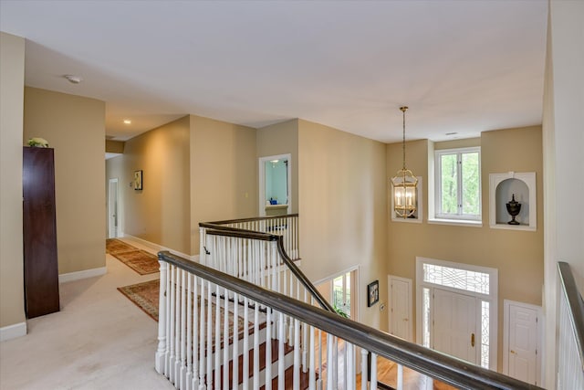 8 Tall Pine Ct, Augusta, GA 30909 - corridor with an upstairs landing, a chandelier, baseboards, and light carpet