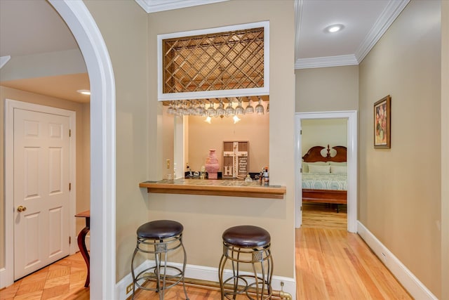 8 Tall Pine Ct, Augusta, GA 30909 - indoor dry bar with crown molding, baseboards, arched walkways, light wood-style flooring, and recessed lighting