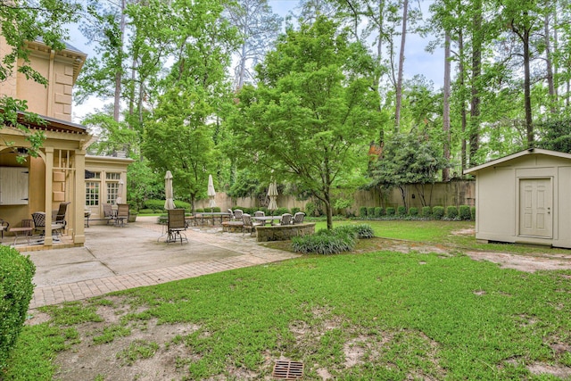 8 Tall Pine Ct, Augusta, GA 30909 - view of yard featuring a storage unit, a patio, and an outbuilding