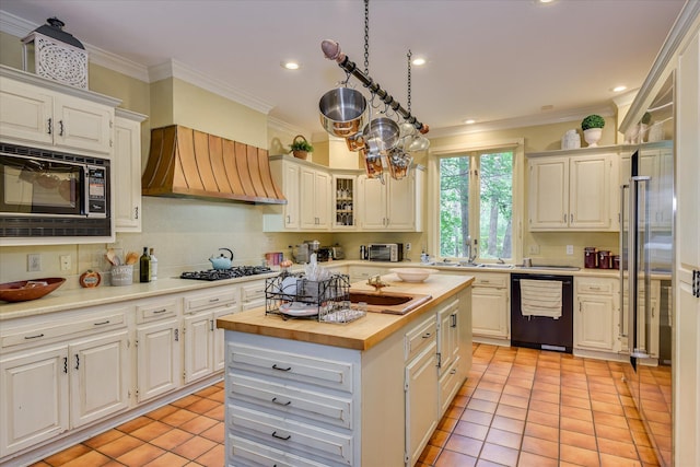 8 Tall Pine Ct, Augusta, GA 30909 - kitchen with black appliances, butcher block countertops, custom range hood, light tile patterned floors, and ornamental molding
