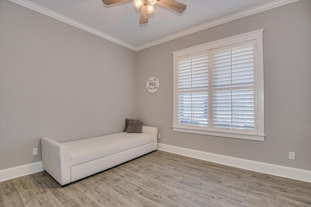 living area featuring ceiling fan, crown molding, baseboards, and wood finished floors