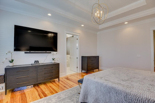 bedroom with a raised ceiling, light wood-style flooring, ornamental molding, an inviting chandelier, and recessed lighting