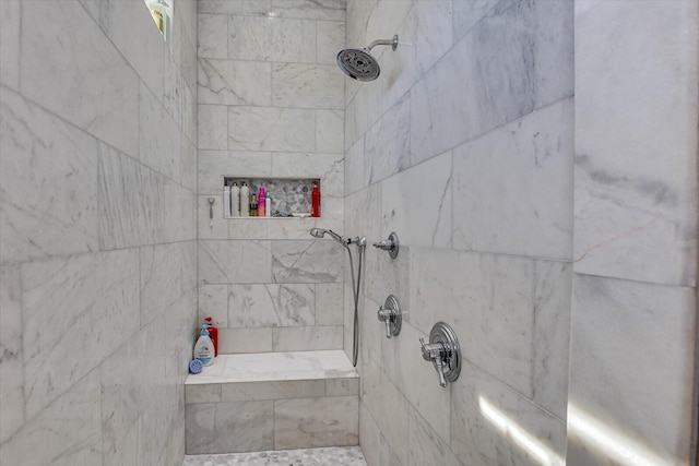 full bathroom featuring tiled shower