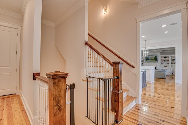 staircase with recessed lighting, wood-type flooring, and crown molding