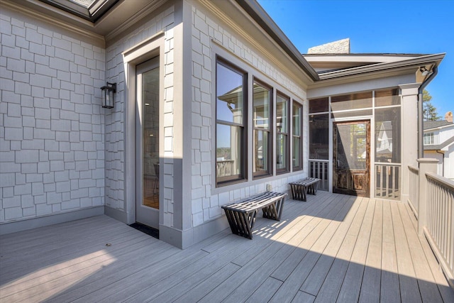 wooden deck with a sunroom