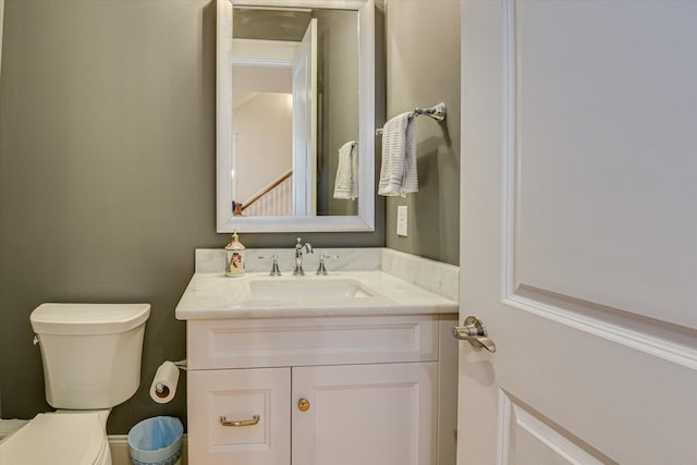 half bath featuring toilet and vanity