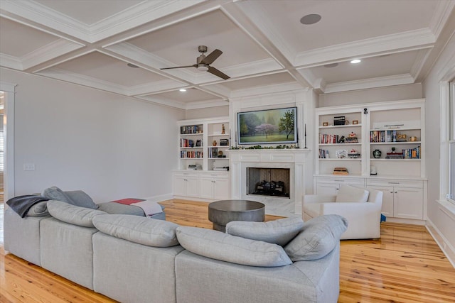 living area featuring beam ceiling, coffered ceiling, and a fireplace