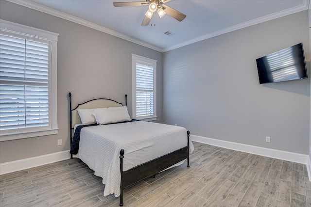 bedroom with ceiling fan, light wood-style flooring, visible vents, baseboards, and ornamental molding