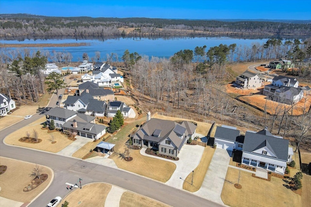 bird's eye view with a water view, a residential view, and a view of trees