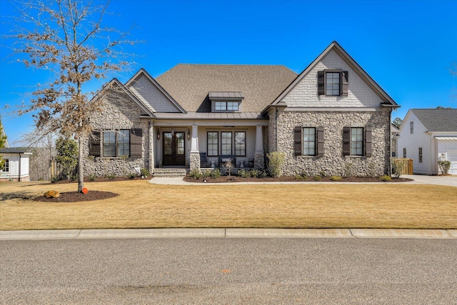 craftsman-style home with a front yard, a standing seam roof, metal roof, and french doors