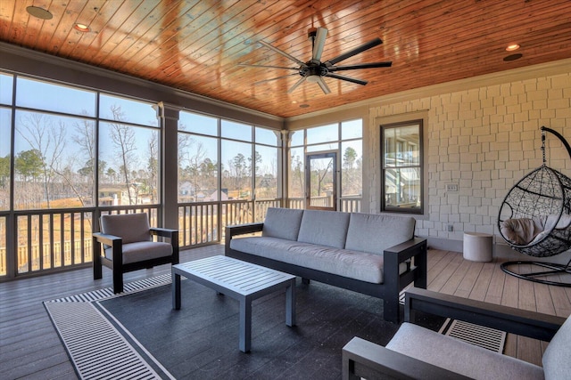 sunroom / solarium with a ceiling fan and wood ceiling