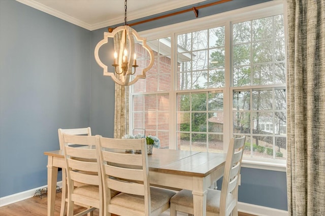 dining room featuring a notable chandelier, crown molding, and wood-type flooring