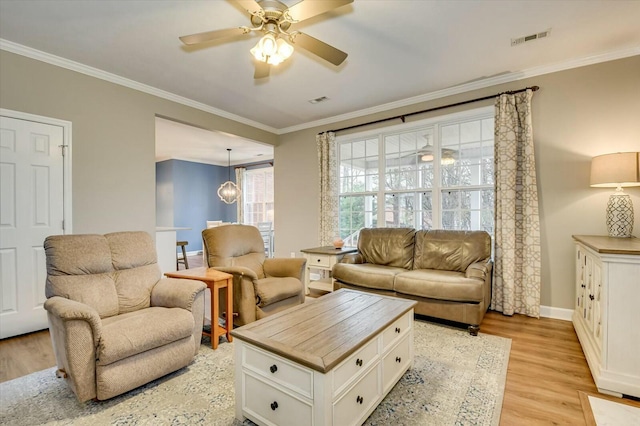 living room with light hardwood / wood-style flooring, ornamental molding, and ceiling fan