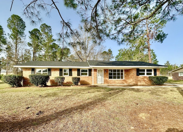 single story home with a front yard and brick siding