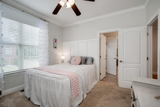 carpeted bedroom with ceiling fan and crown molding