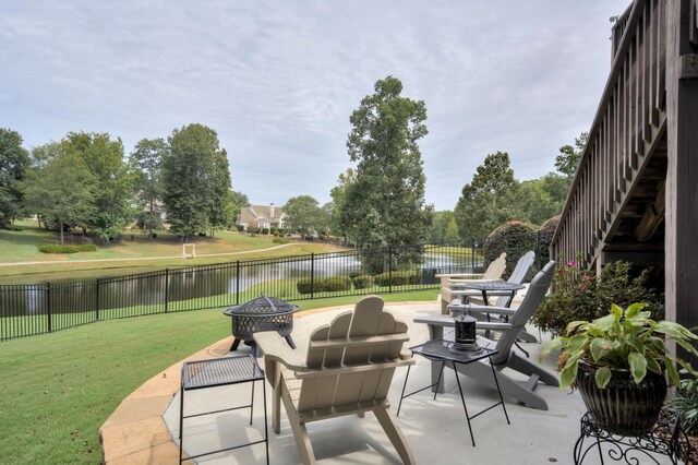 view of patio / terrace featuring a water view and a fire pit