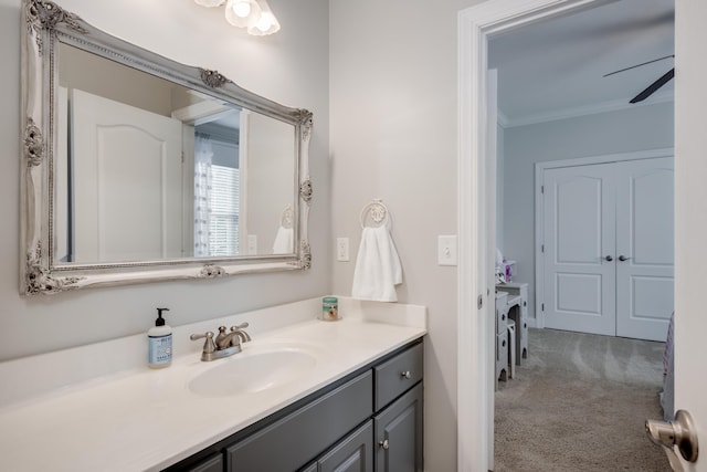 bathroom with vanity, ceiling fan, and ornamental molding