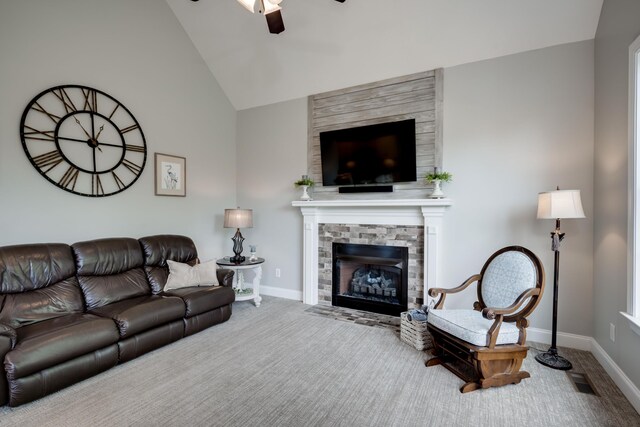 living room with ceiling fan, a fireplace, carpet, and lofted ceiling