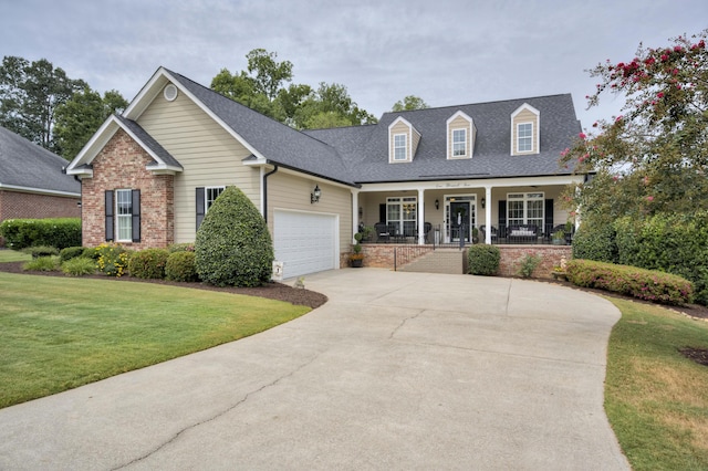 view of front facade with a porch, a garage, and a front yard