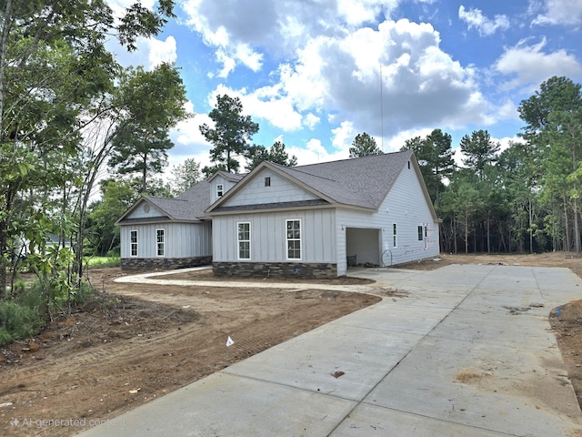 1403 Bellingham Dr, Beech Island, SC 29842 - view of front facade with concrete driveway, a shingled roof, board and batten siding, and a garage