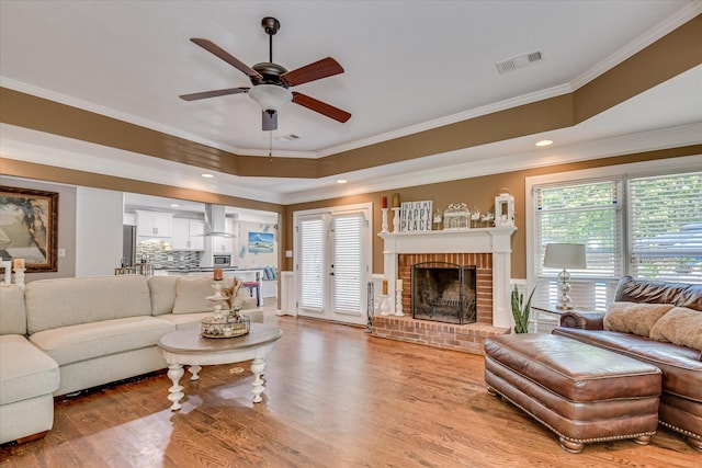 466 Cambridge Way, Martinez, GA 30907 - living room featuring ceiling fan, healthy amount of natural light, light wood-style floors, crown molding, and a brick fireplace
