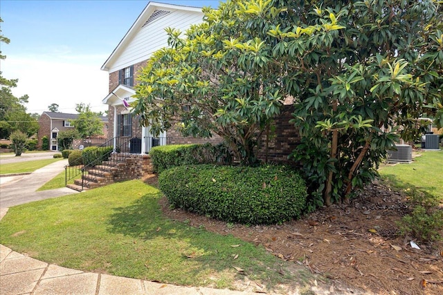 2920 Arrowhead Dr, Augusta, GA 30909 - view of front facade featuring brick siding, a front yard, and central AC