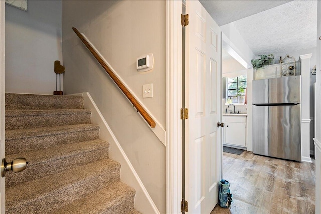 2920 Arrowhead Dr, Augusta, GA 30909 - staircase with a textured ceiling and wood finished floors
